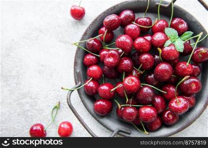 Fresh red cherries fruit  on a concrete background