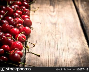 Fresh red cherry . On a wooden background.. Fresh red cherry