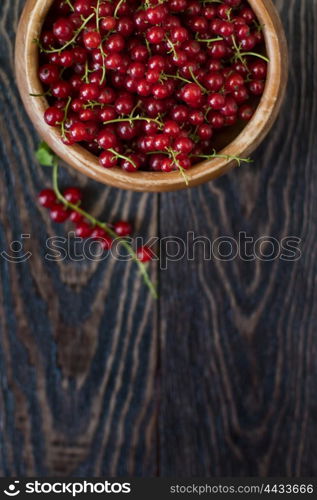 Fresh red currants. Fresh red currants in plate on wooden table