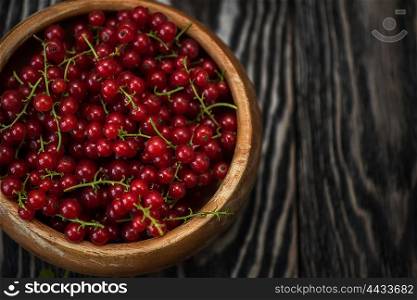 Fresh red currants. Fresh red currants in plate on wooden table