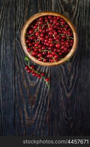 Fresh red currants. Fresh red currants in plate on wooden table