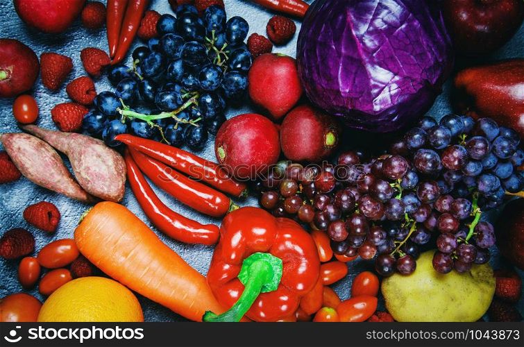 Fresh red fruit and purple red vegetables mixed background , top view various for healthy food vegan cook / Healthy food selection clean eating for heart life cholesterol diet health concept