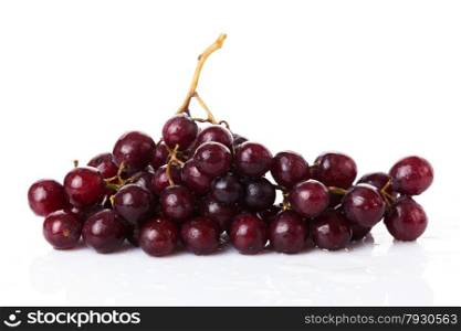 Fresh red grapes and water drops isolated on white background