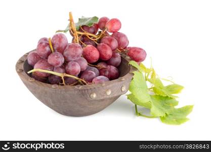 Fresh red grapes in wood bown isolated on white background.