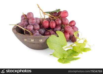 Fresh red grapes in wood bown isolated on white background.
