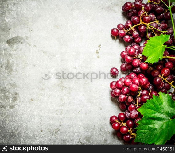 Fresh red grapes. On the stone table.. Fresh red grapes.