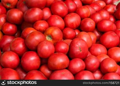Fresh red heirloom tomato background as abundance harvest symbol. Healthy eating concept with ripe fruits vegetables