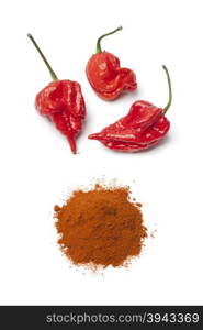 Fresh red hot scorpion chili peppers and chili powder on white background