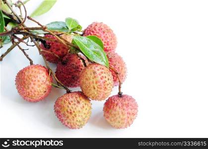 Fresh red lichi fruits with green leaves on a white background