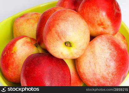 Fresh red nectarines in the green vase