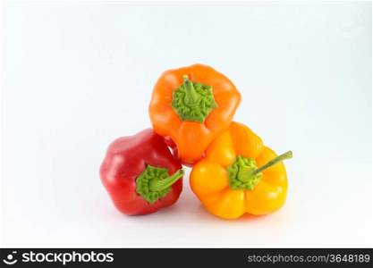 fresh red, orange and yellow Bell peppers isolated on white