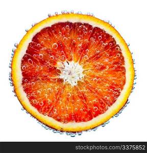 fresh red orange falls in water on a white background