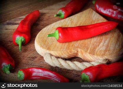Fresh red peppers paprika on wooden background . Top view .. Fresh red peppers paprika on wooden background . Top view