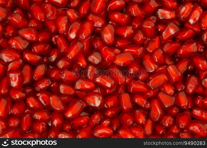 Fresh red seeds of pomegranate. Food pattern texture background. 