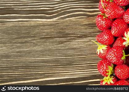 fresh red strawberries on a brown wooden background, banner, flat lay with copy space.. strawberry on a wooden background