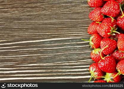 fresh red strawberries on a brown wooden background. strawberry on a wooden background