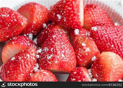 Fresh red strawberries with sugar in a bowl