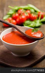 fresh red tomato sauce with basil leaf and wooden spoon