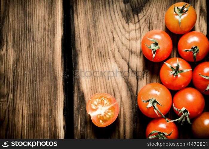 Fresh red tomatoes . On a wooden background.. Fresh red tomatoes . On wooden background.
