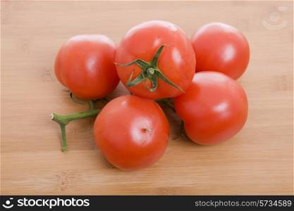 Fresh red tomatoes on the wooden table