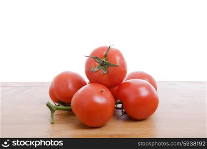 Fresh red tomatoes on the wooden table
