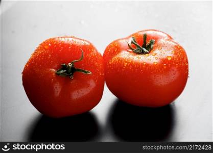Fresh red tomatoes with drops of water. Farm vegetables for vegan diet.. Fresh tomatoes with drops of water. Farm vegetables for vegan diet.