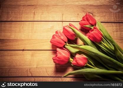 Fresh red tulip flowers bouquet on wood. Natural spring or Valentine&rsquo;s Day, Mother&rsquo;s Day theme. . Fresh red tulip flowers bouquet on wood. Vintage