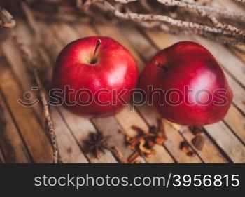 Fresh red two couple apple on brown rustic board with spices, concept.