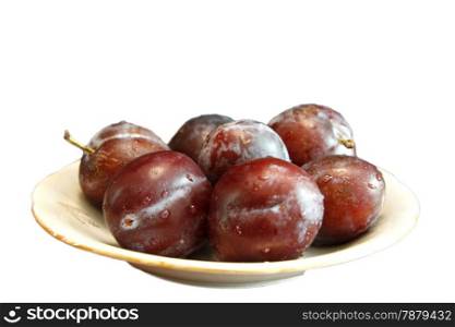 Fresh Ripe Black Plums In A White Plate Isolated On White Background