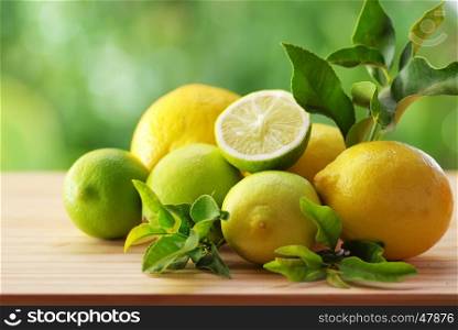 Fresh ripe citruses with leaves on wood table
