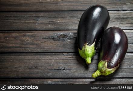 Fresh ripe eggplant. On black wooden background. Fresh ripe eggplant.