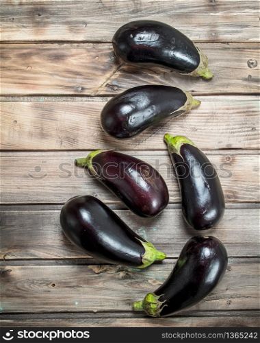 Fresh ripe eggplant. On wooden background. Fresh ripe eggplant.