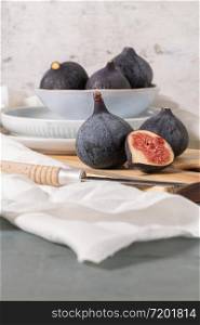 Fresh ripe figs on a wooden table. Healthy Mediterranean figs. Beautiful blue purple figs, selective focus.