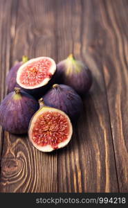 Fresh ripe figs on a wooden table. Healthy Mediterranean figs. Beautiful blue purple figs, selective focus.. Fresh ripe figs on a wooden table. Healthy Mediterranean figs. Beautiful blue purple figs, selective focus