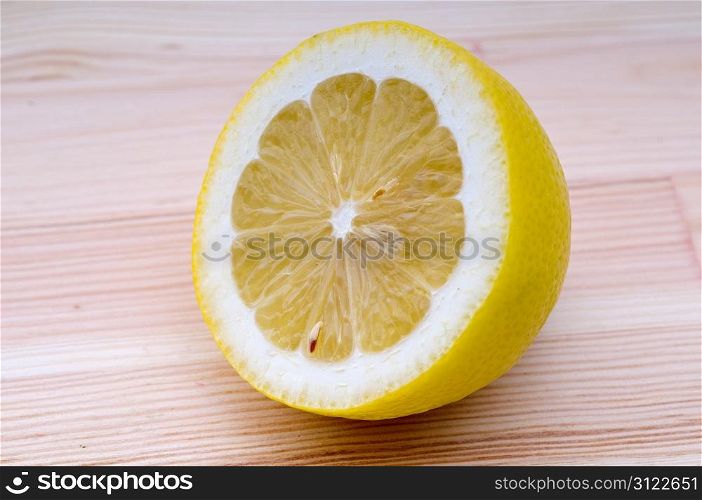 fresh ripe lemon cutted in half closedup over wood table