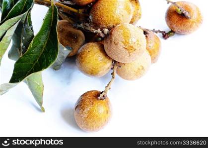 Fresh ripe longan fruits on a white background