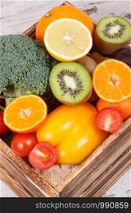 Fresh ripe natural fruits with vegetables in rustic box as food containing healthy minerals and vitamins. Fresh fruits with vegetables in rustic box as food containing healthy minerals and vitamins