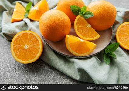 Fresh ripe oranges on dark concrete background