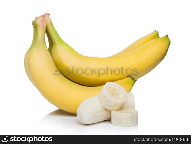 Fresh ripe organic bananas cluster with sliced pieces on white.