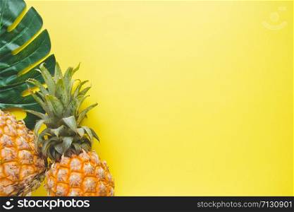 Fresh ripe pineapple and leaf of monstera tree on color background, top view.