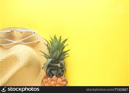 Fresh ripe pineapple glasses hat on color background, top view