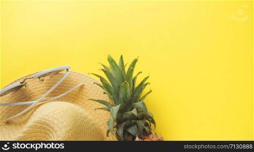 Fresh ripe pineapple glasses hat on color background, top view
