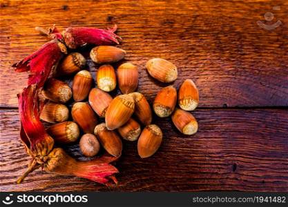 Fresh ripe red hazelnuts on wooden table