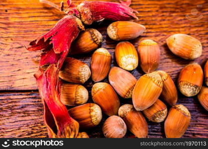 Fresh ripe red hazelnuts on wooden table