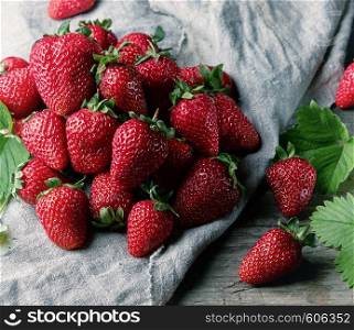 fresh ripe red strawberries on a wooden table, top view