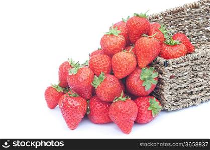 Fresh ripe strawberries in rustic woven basket isolated on white background