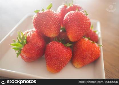Fresh ripe strawberries on white plate, stock photo