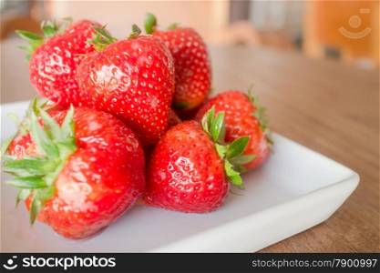 Fresh ripe strawberries on white plate, stock photo