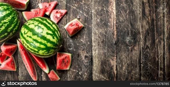 Fresh ripe watermelon. On a wooden background.. Fresh ripe watermelon.