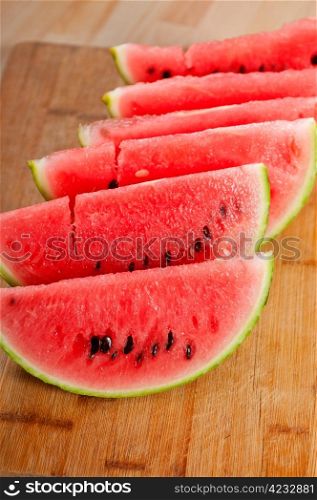 fresh ripe watermelon sliced on a wood table